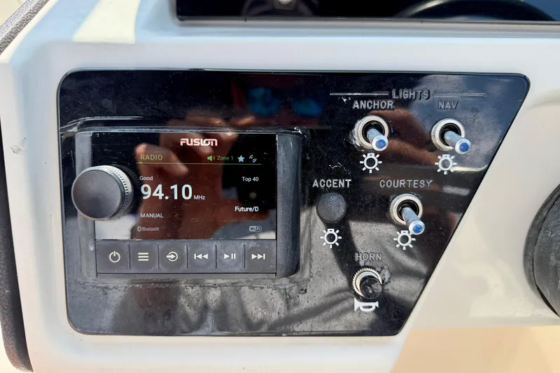 Slide: The Image of Control panel of 2022 Sea Ray SPX 230 Outboard with radio and light switches. - 15