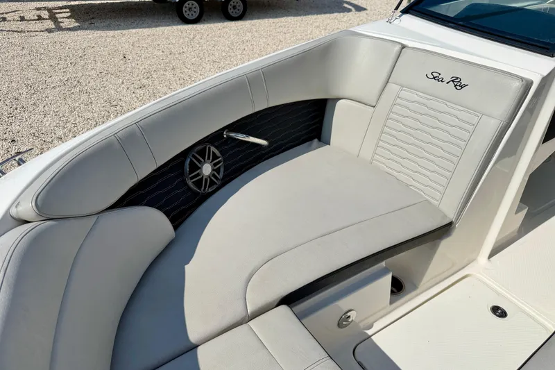 Slide: The Image of 2022 Sea Ray SPX 230 Outboard boat interior with cushioned seating and speaker. - 11