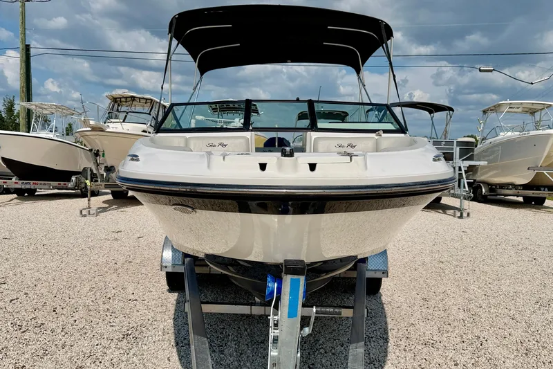 Slide: The Image of 2022 Sea Ray SPX 230 Outboard boat on trailer, displayed outdoors. - 2