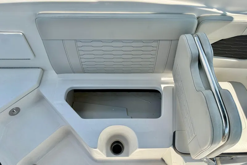 Slide: The Image of 2022 Sea Ray SPX 230 Outboard boat interior with storage compartment and seating. - 29