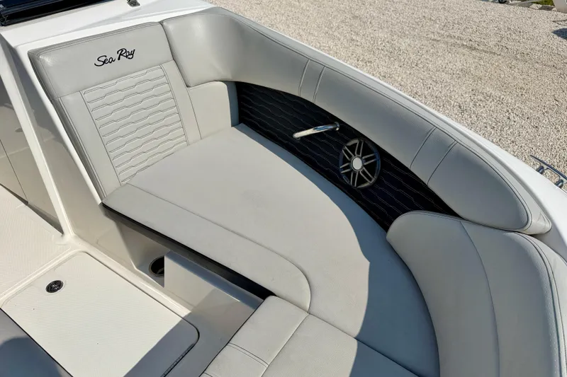 Slide: The Image of 2022 Sea Ray SPX 230 Outboard boat interior with gray seating and speaker detail. - 10