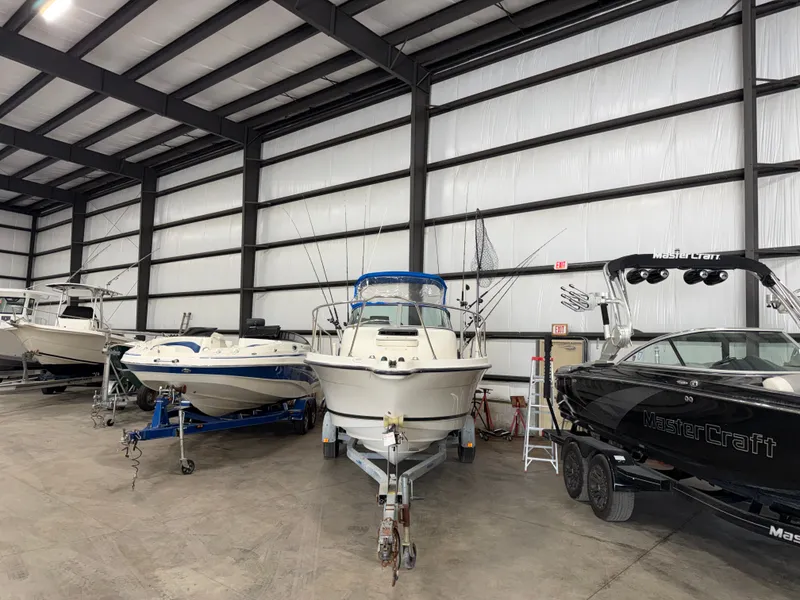 Slide: The Image of A 2000 Bayliner Trophy 2002FF is in a storage facility alongside other boats. - 2