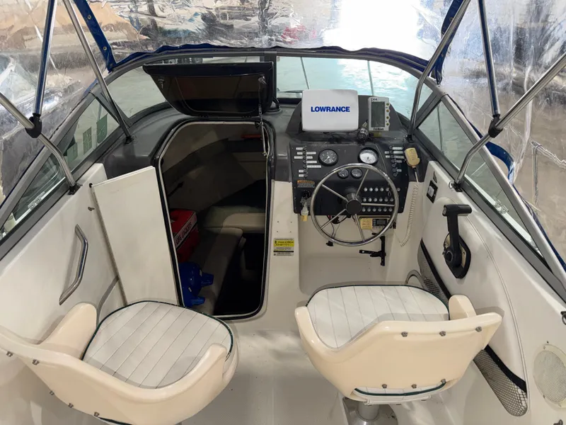 Slide: The Image of The image shows the cockpit of a 2000 Bayliner Trophy 2002FF with two white seats and a helm. - 18