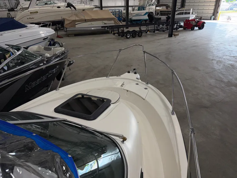 Slide: The Image of A 2000 Bayliner Trophy 2002FF is in a warehouse, surrounded by other boats. - 6