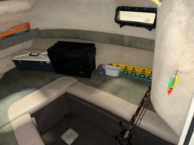 Slide: The Image of Interior of a 2000 Bayliner Trophy 2002FF with seating area and fishing rods. - 22
