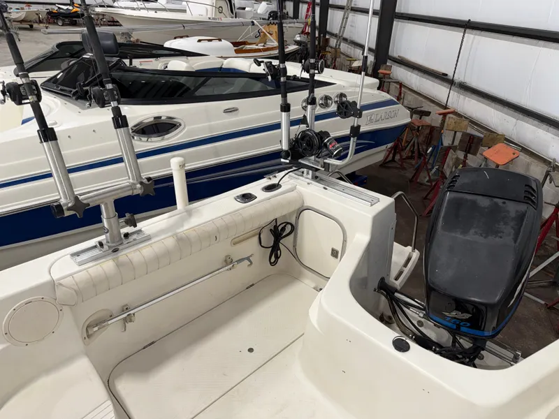 Slide: The Image of The image shows the cockpit of a 2000 Bayliner Trophy 2002FF with fishing rod holders and an outboard motor. - 11