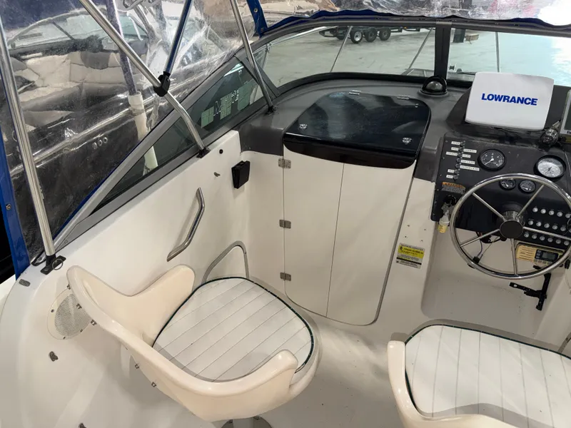 Slide: The Image of The image shows the cockpit of a 2000 Bayliner Trophy 2002FF with two white seats and a helm station. - 14