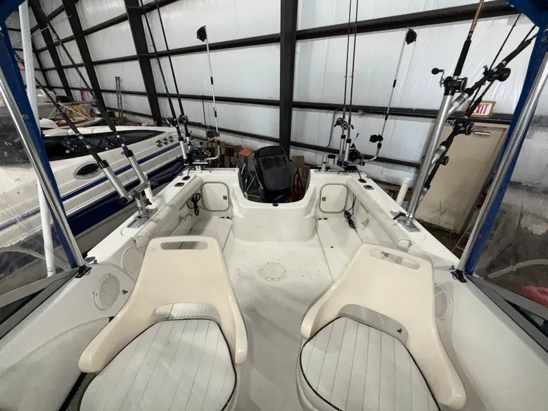 Slide: The Image of The image shows the cockpit of a 2000 Bayliner Trophy 2002FF with two seats and fishing rods. - 17