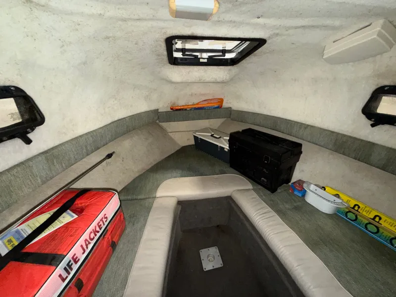 Slide: The Image of Interior of a 2000 Bayliner Trophy 2002FF with seating, storage, and life jackets. - 19