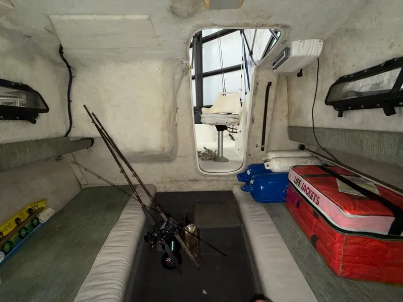 Slide: The Image of Interior of a 2000 Bayliner Trophy 2002FF with fishing rods and life jackets. - 23
