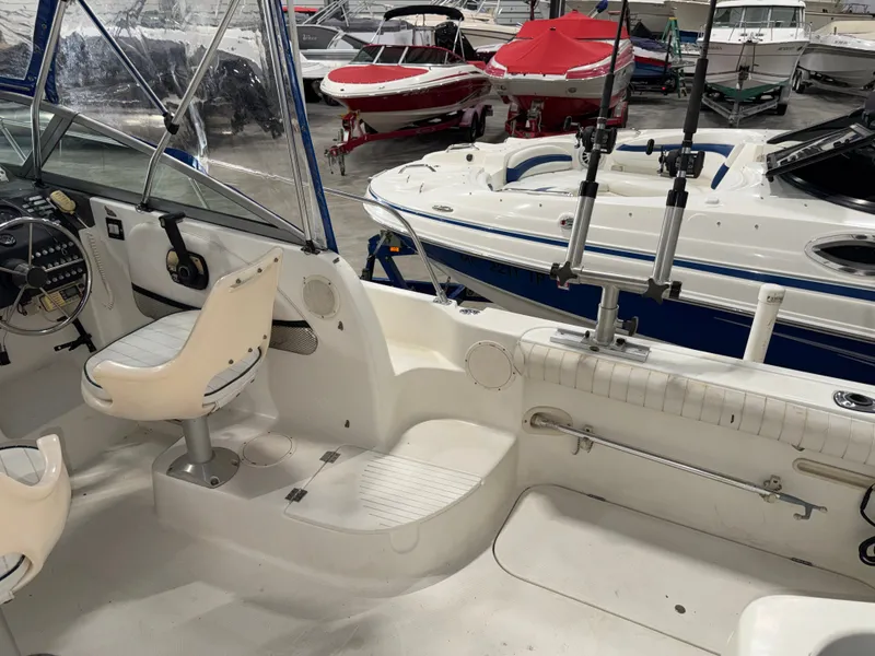 Slide: The Image of The image shows the cockpit of a 2000 Bayliner Trophy 2002FF with white seats and steering. - 10