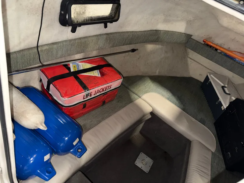Slide: The Image of The image shows the interior of a Bayliner Trophy 2002FF boat with life jackets and fenders. - 21