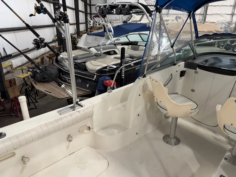 Slide: The Image of The image shows the cockpit of a 2000 Bayliner Trophy 2002FF boat in a storage facility. - 13