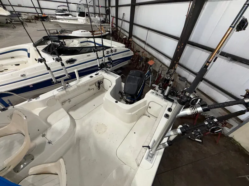Slide: The Image of The image shows a 2000 Bayliner Trophy 2002FF boat in a storage facility with fishing rods. - 9
