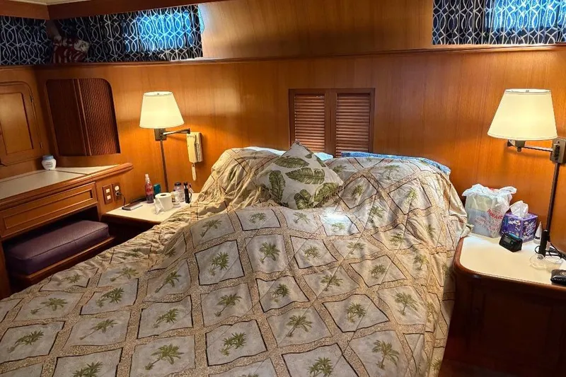 Slide: The Image of Cozy bedroom in 1990 Hi-Star Trawler with wood paneling and decorative bedding. - 30