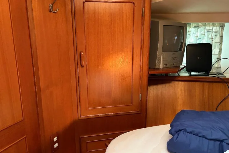Slide: The Image of Interior of 1990 Hi-Star Trawler with wooden cabinetry and vintage TV setup. - 19