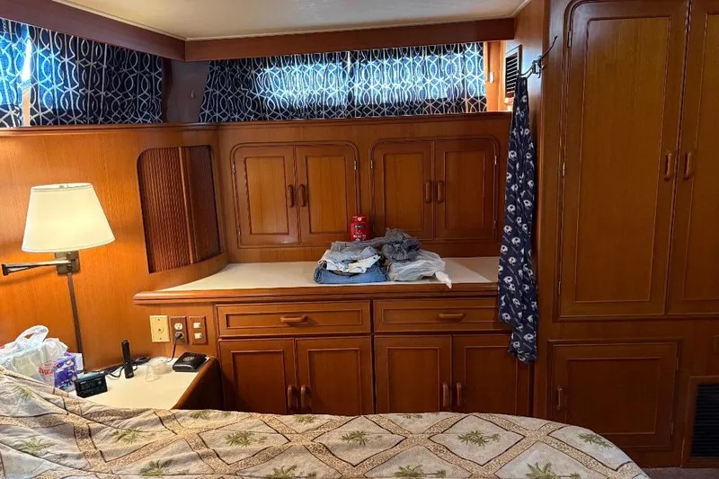Slide: The Image of Cozy 1990 Hi-Star Trawler cabin interior with wooden cabinetry and nautical decor. - 28