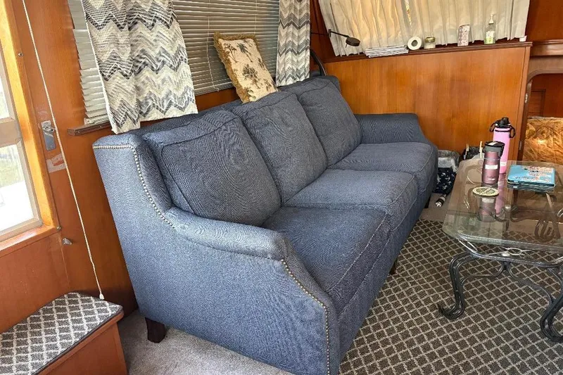 Slide: The Image of Cozy interior of 1990 Hi-Star Trawler with blue sofa and glass coffee table. - 12