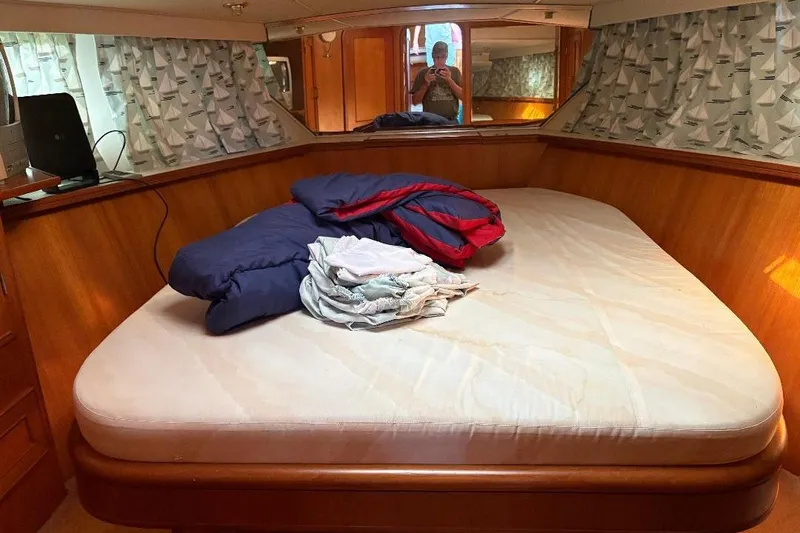 Slide: The Image of Cozy cabin interior of 1990 Hi-Star Trawler with bed and nautical-themed curtains. - 21