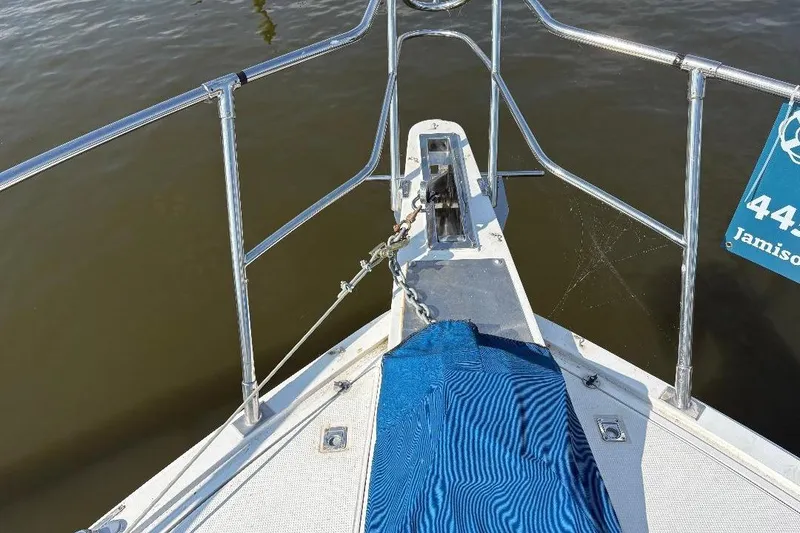 Slide: The Image of Bow view of 1990 Hi-Star Trawler with anchor chain and blue cover. - 3