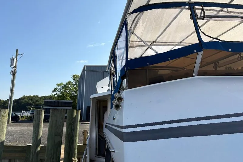 Slide: The Image of 1990 Hi-Star TRAWLER boat docked, featuring a blue canopy and white exterior. - 38