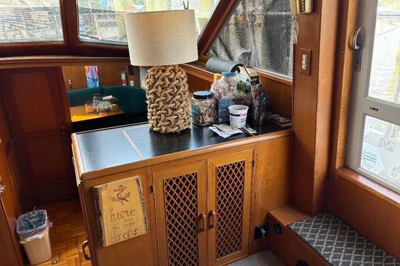 Slide: The Image of Interior of a 1990 Hi-Star Trawler with wooden cabinetry and nautical decor. - 9