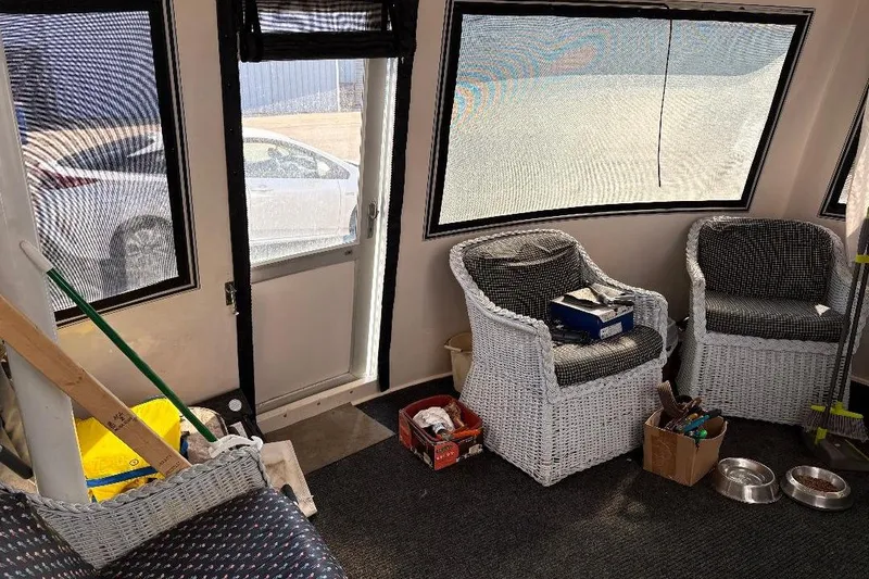 Slide: The Image of Interior of a 1990 Hi-Star Trawler with wicker chairs and nautical decor. - 26