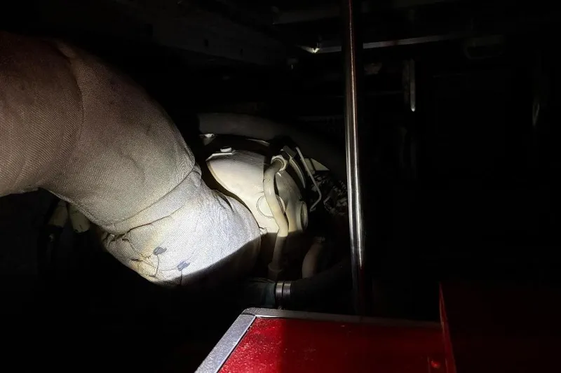 Slide: The Image of Engine room of 1990 Hi-Star Trawler with visible exhaust pipe and components. - 22