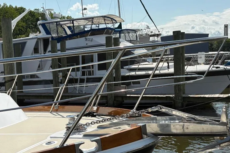 Slide: The Image of 1990 Hi-Star TRAWLER docked at marina, featuring polished railings and anchor chain. - 6
