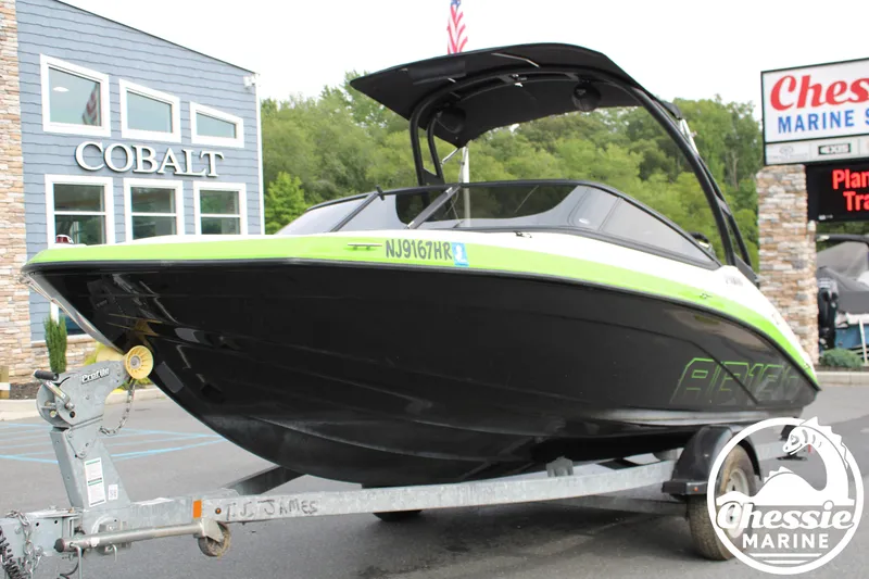 The Image of A 2022 Yamaha AR190 boat on a trailer in front of a building. - 1
