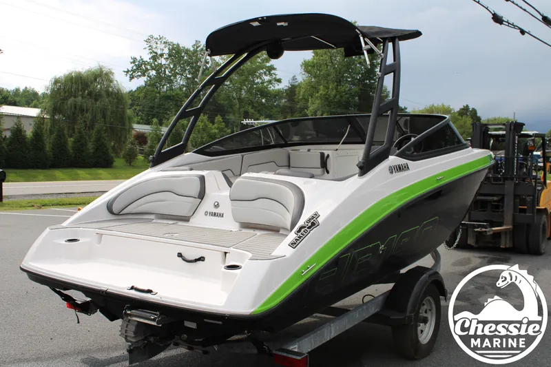 Slide: The Image of A 2022 Yamaha AR190 boat on a trailer, featuring a green stripe and black bimini top. - 5