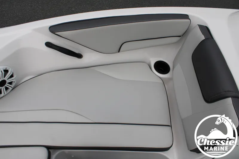 Slide: The Image of The interior of a 2022 Yamaha AR190 boat with gray and black upholstery and a speaker. - 19