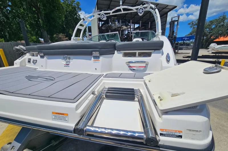Slide: The Image of 2023 Chaparral 23 SSi boat with swim platform and ladder, docked outdoors. - 5