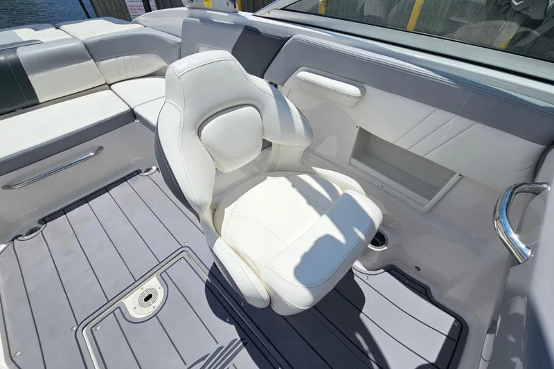 Slide: The Image of 2023 Chaparral 23 SSi boat interior with white seating and sleek design. - 13