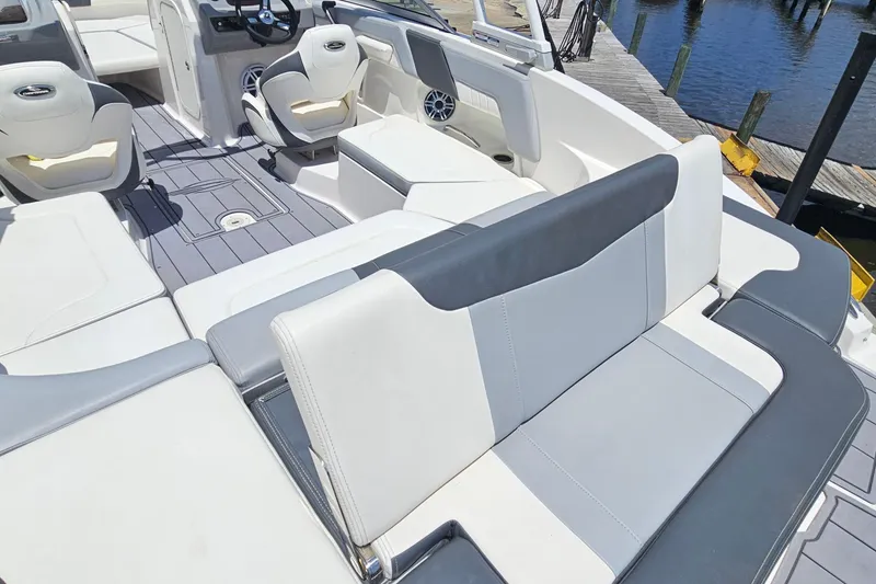 Slide: The Image of 2023 Chaparral 23 SSi boat interior with stylish seating and modern dashboard design. - 8