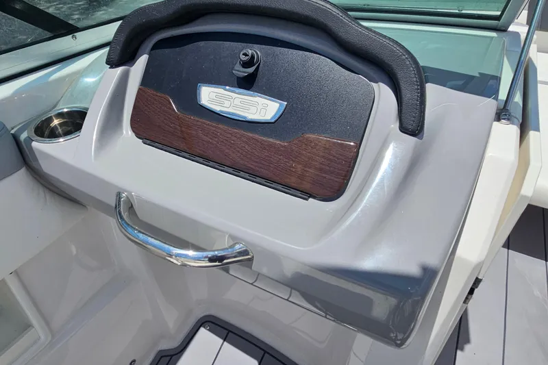 Slide: The Image of 2023 Chaparral 23 SSi boat dashboard with sleek design and cup holder. - 17