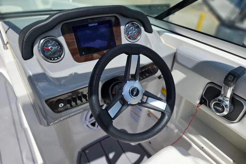 Slide: The Image of 2023 Chaparral 23 SSi boat dashboard with steering wheel and control panel. - 15