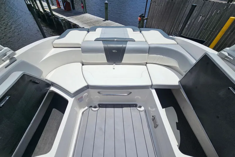 Slide: The Image of 2023 Chaparral 23 SSi boat interior with white seating and storage compartments. - 11