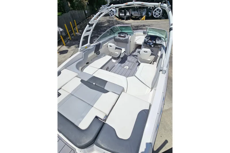 Slide: The Image of 2023 Chaparral 23 SSi boat interior with sleek seating and modern dashboard design. - 25