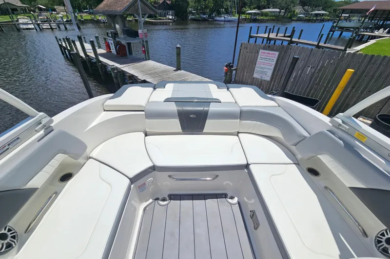 Slide: The Image of 2023 Chaparral 23 SSi boat interior with spacious seating and waterfront view. - 7