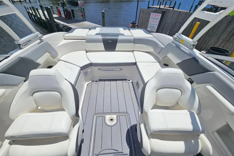 Slide: The Image of 2023 Chaparral 23 SSi boat interior with white seating and spacious layout. - 9