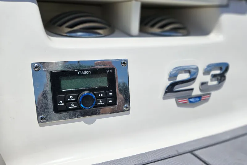 Slide: The Image of 2023 Chaparral 23 SSi boat featuring Clarion CMR-20 audio system and chrome "23" emblem. - 6