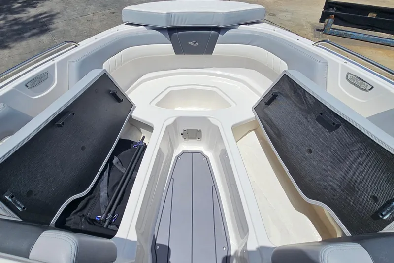 Slide: The Image of 2023 Chaparral 23 SSi boat interior with open storage compartments and seating. - 22