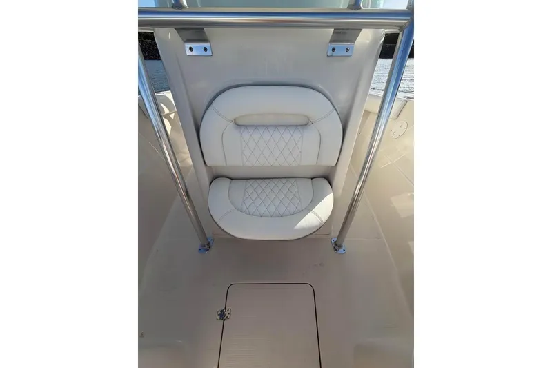 Slide: The Image of 2022 Sailfish 242 CC boat interior with cushioned seating and stainless steel railings. - 4