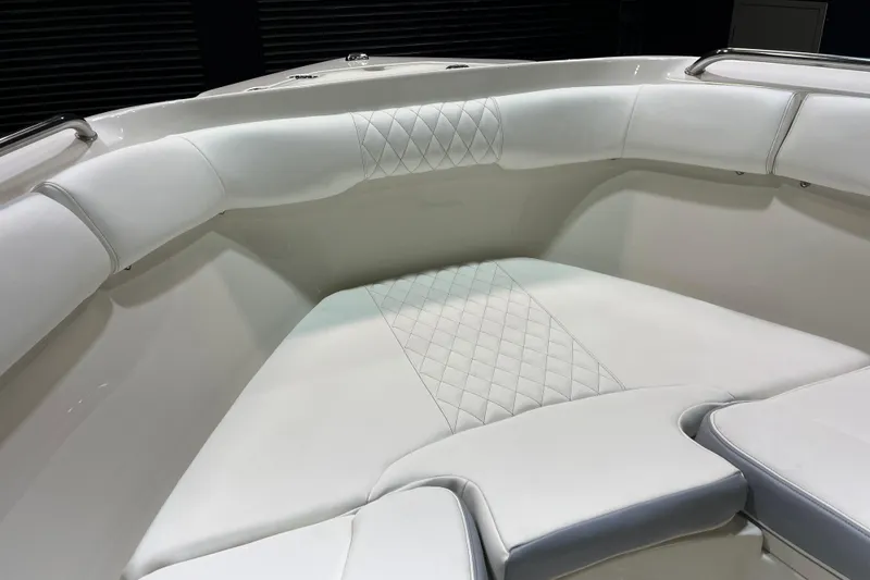 Slide: The Image of Luxurious white seating on 2022 Sailfish 242 CC boat, featuring diamond-pattern upholstery. - 13