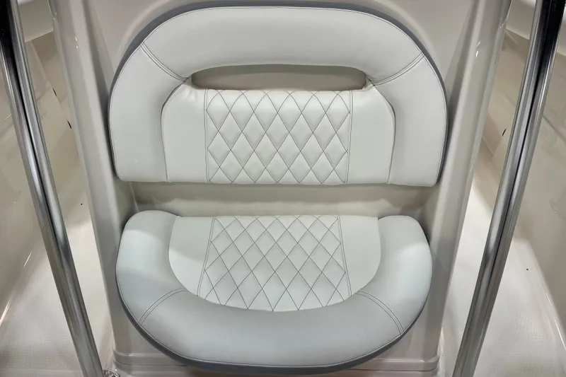 Slide: The Image of Luxurious white seating on 2022 Sailfish 242 CC boat, featuring diamond-patterned upholstery. - 14