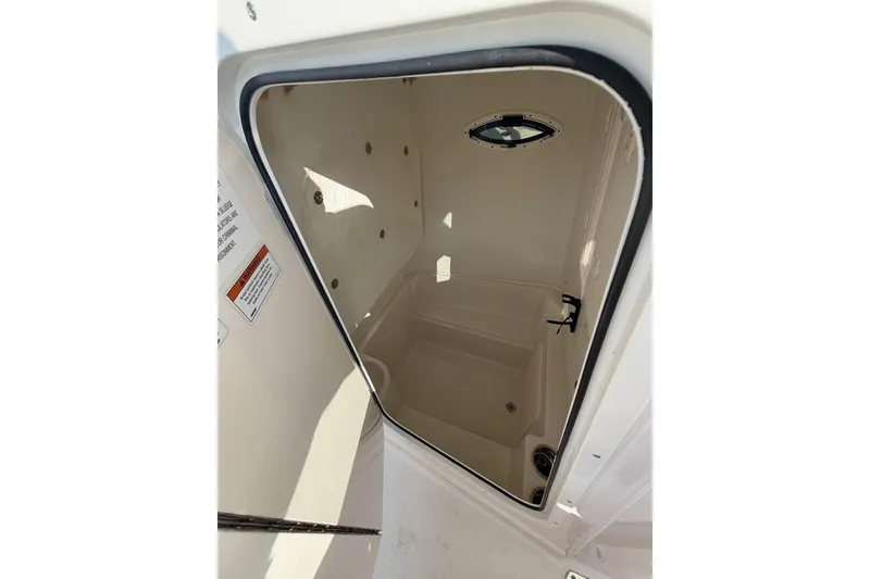 Slide: The Image of 2022 Sailfish 242 CC boat interior compartment with porthole window. - 9
