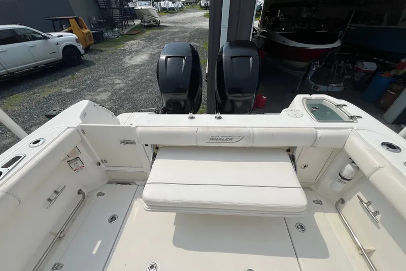 Slide: The Image of 2012 Boston Whaler 285 Conquest boat interior with seating and dual engines. - 17