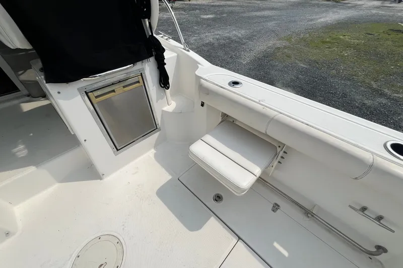 Slide: The Image of 2012 Boston Whaler 285 Conquest boat interior with seating and storage features. - 9
