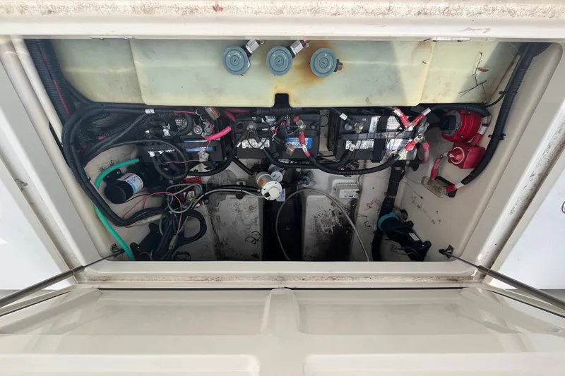 Slide: The Image of 2012 Boston Whaler 285 Conquest engine compartment with wiring and components visible. - 8